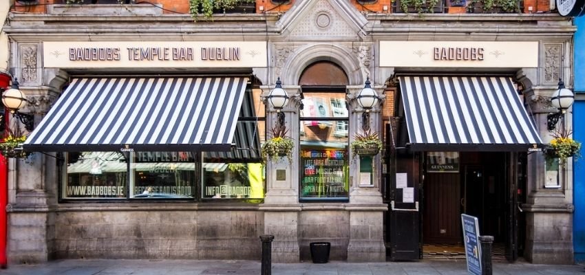 A bar with awnings across its large windows