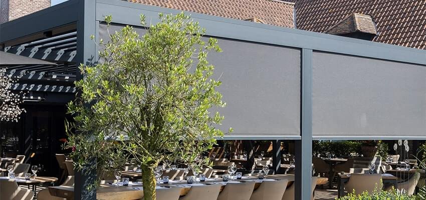 A large pergola structure shading an outdoor eating area