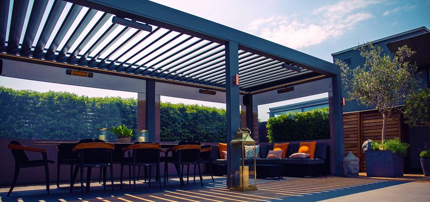 An outdoor commercial pergola with integrated heaters and seating